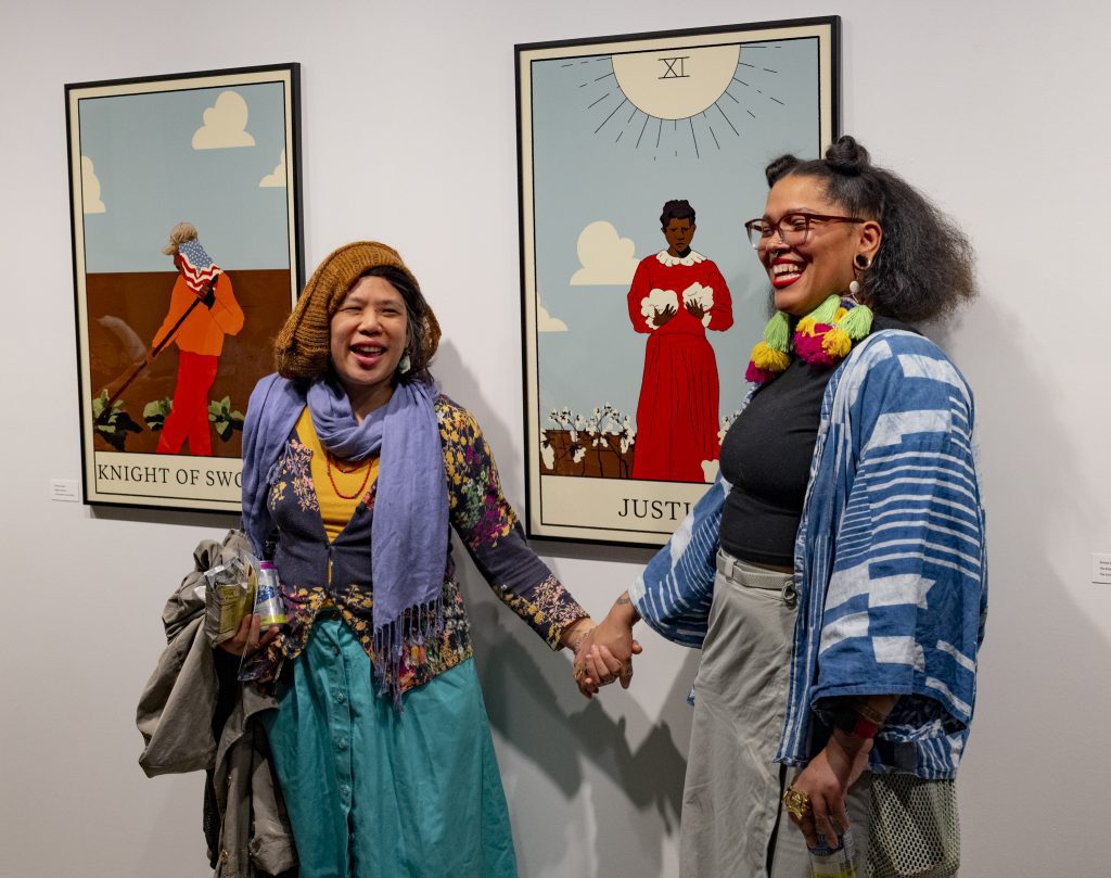Two women smiling in art gallery