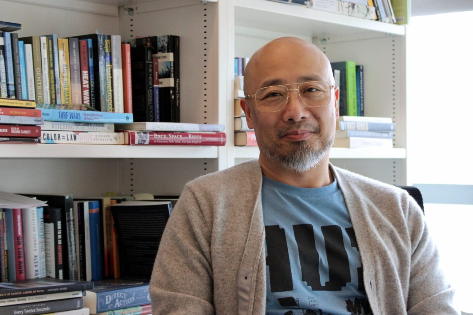 Man sitting in front of bookshelf