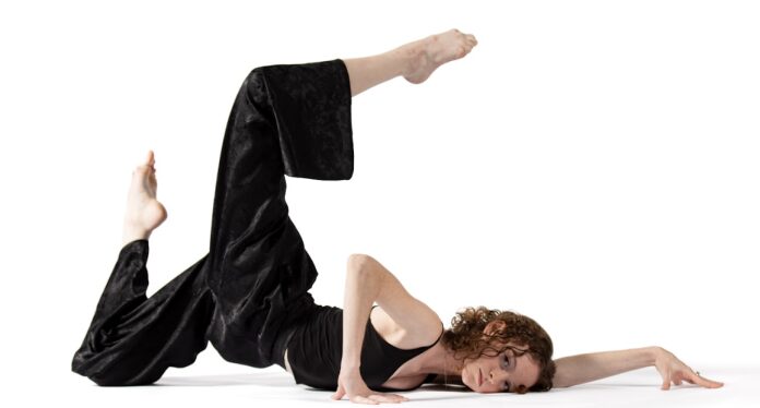 Dancer in black outfit on white background