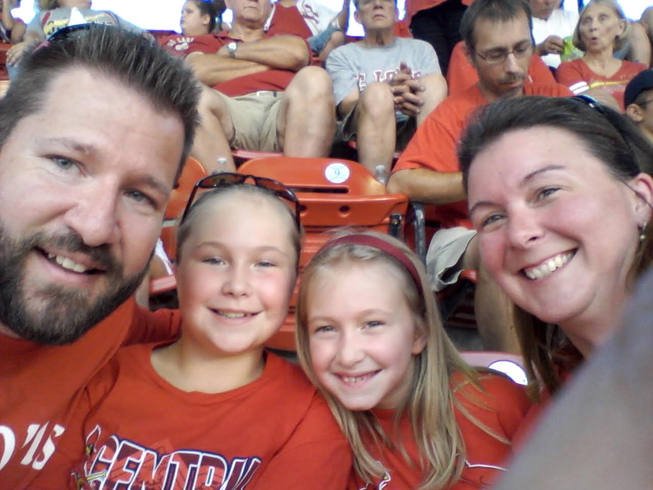 Family in red shirts at game