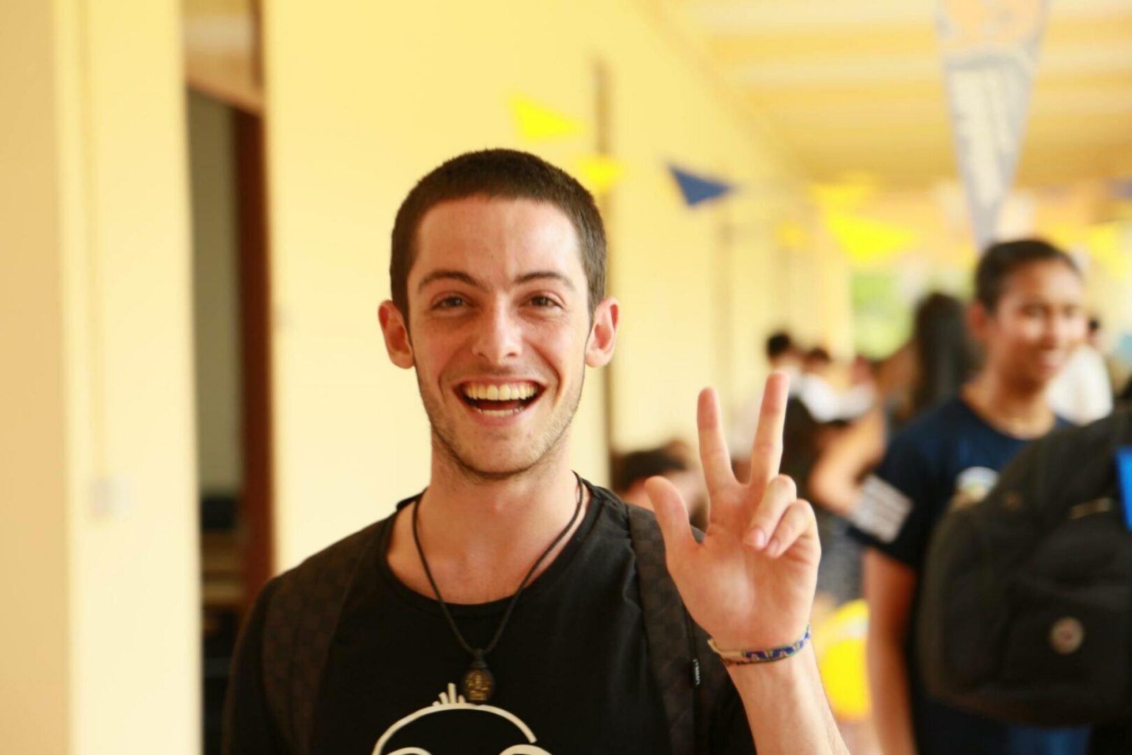 Happy individual in a hallway
