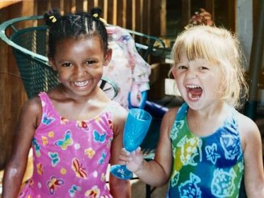 Kids smiling with colorful outfits