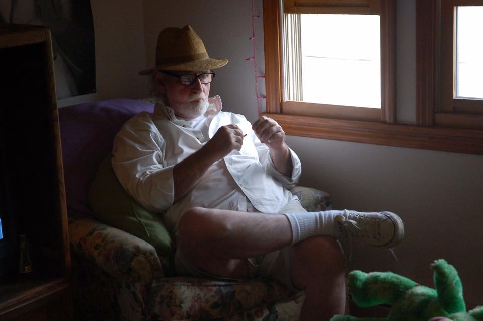 Man in white shirt seated casually