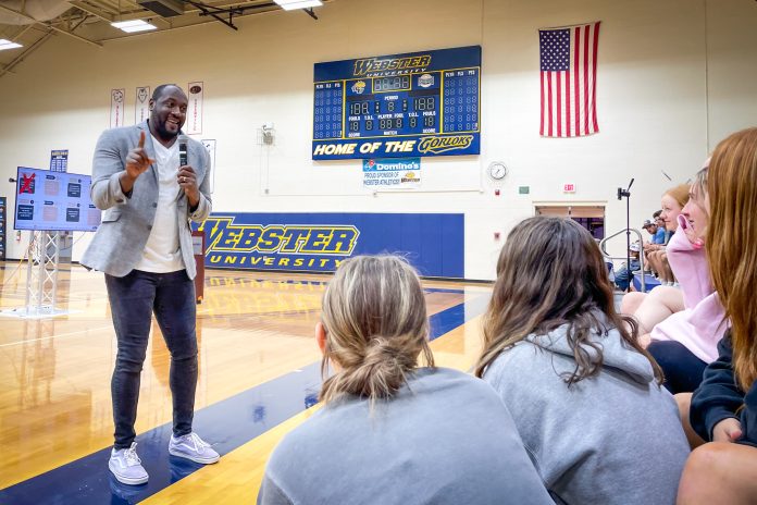 Speaker engaging audience in gymnasium