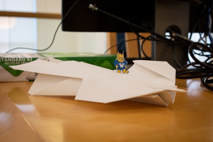 Small mascot on paper airplane