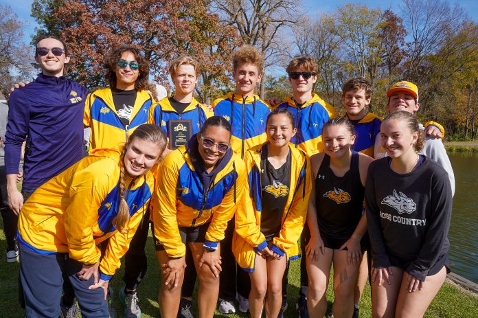 Happy athletes gathered by a lake