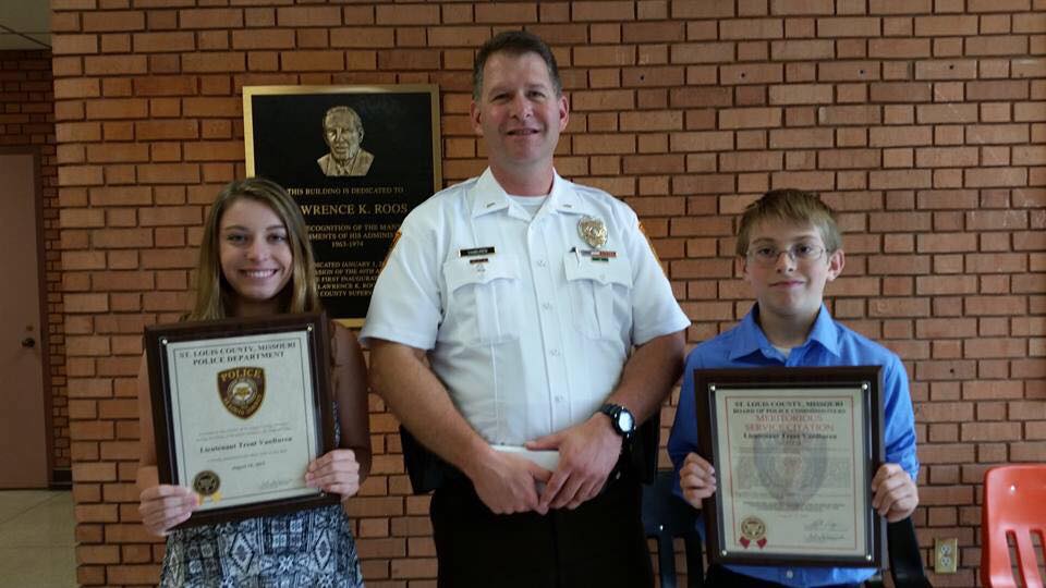 Officer with two award recipients