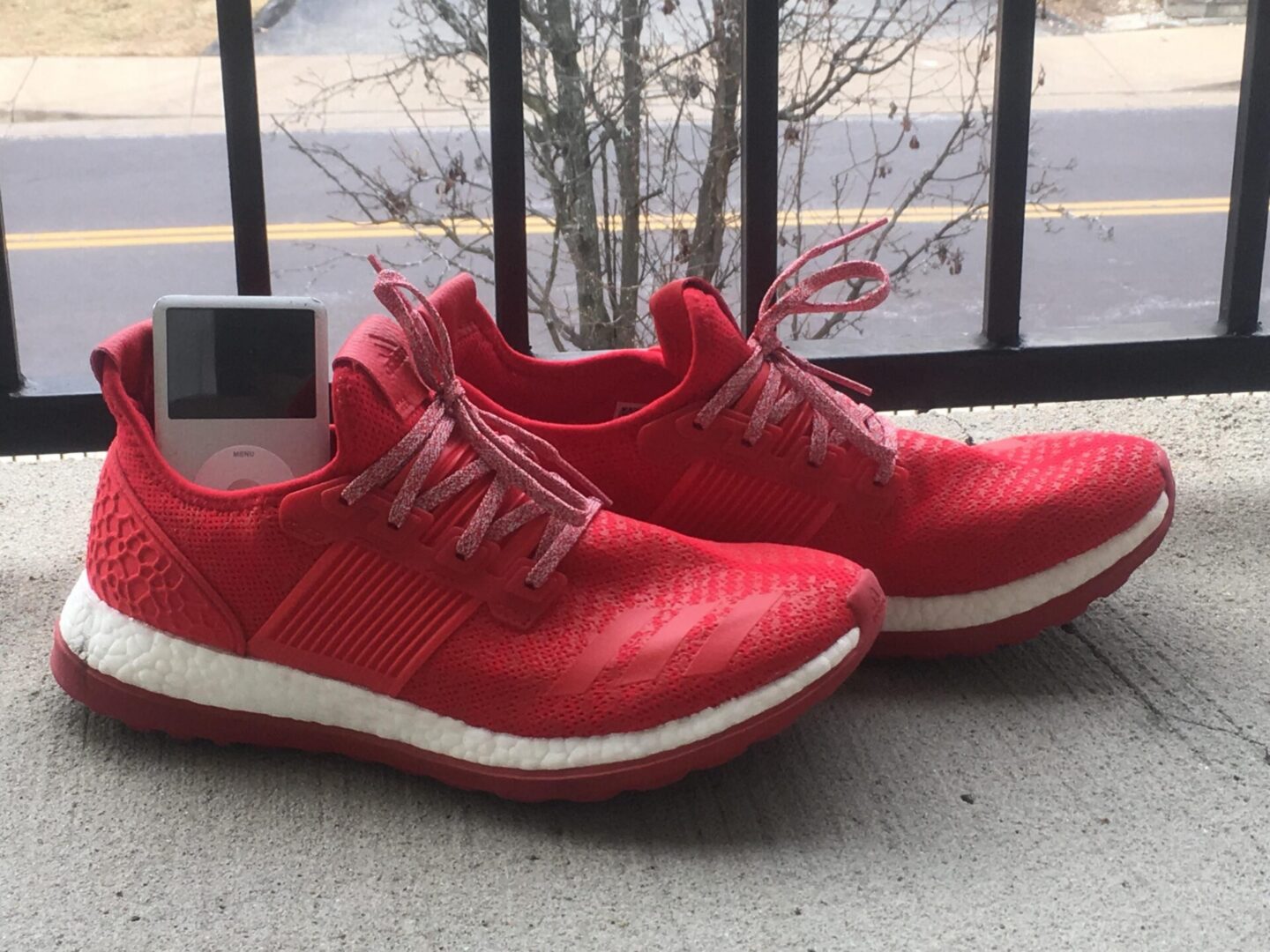 Bright red sneakers on concrete surface