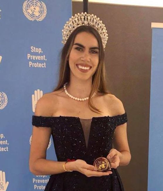 Pageant winner posing with prize