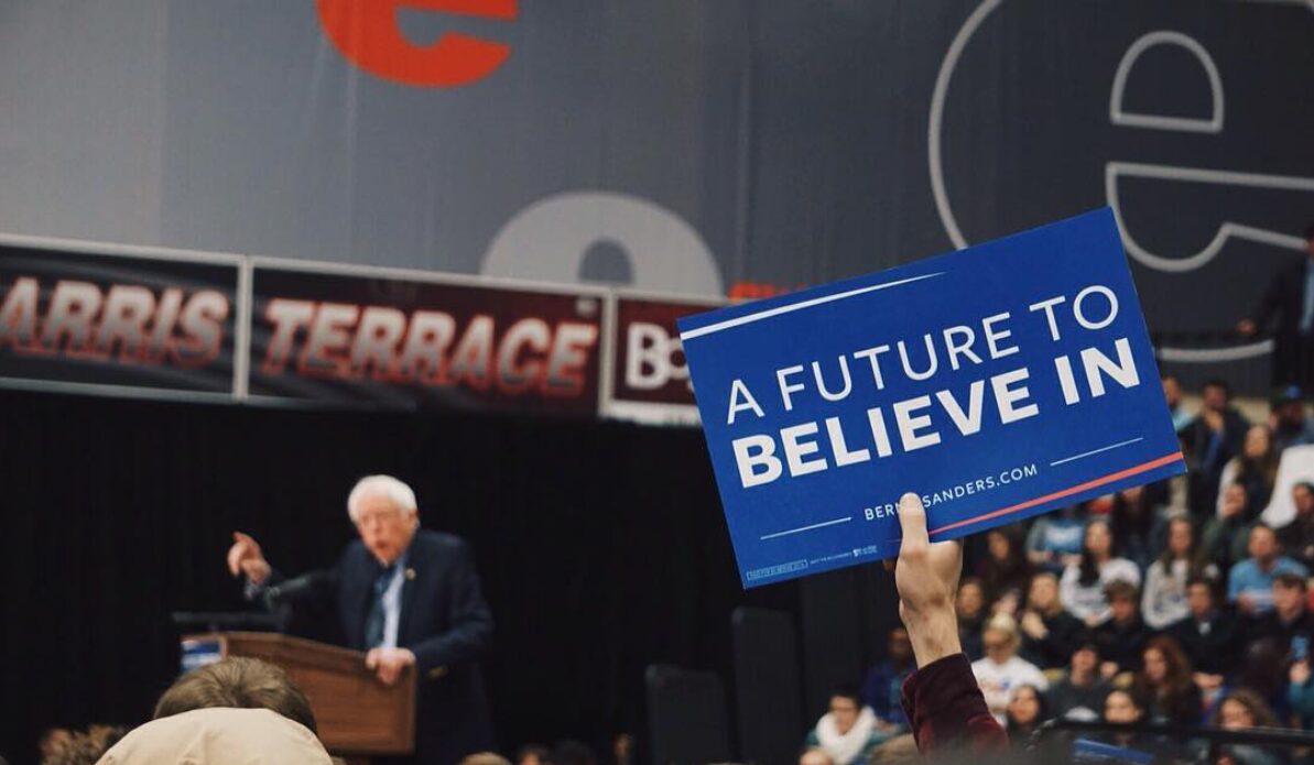 Supporter holding motivational sign