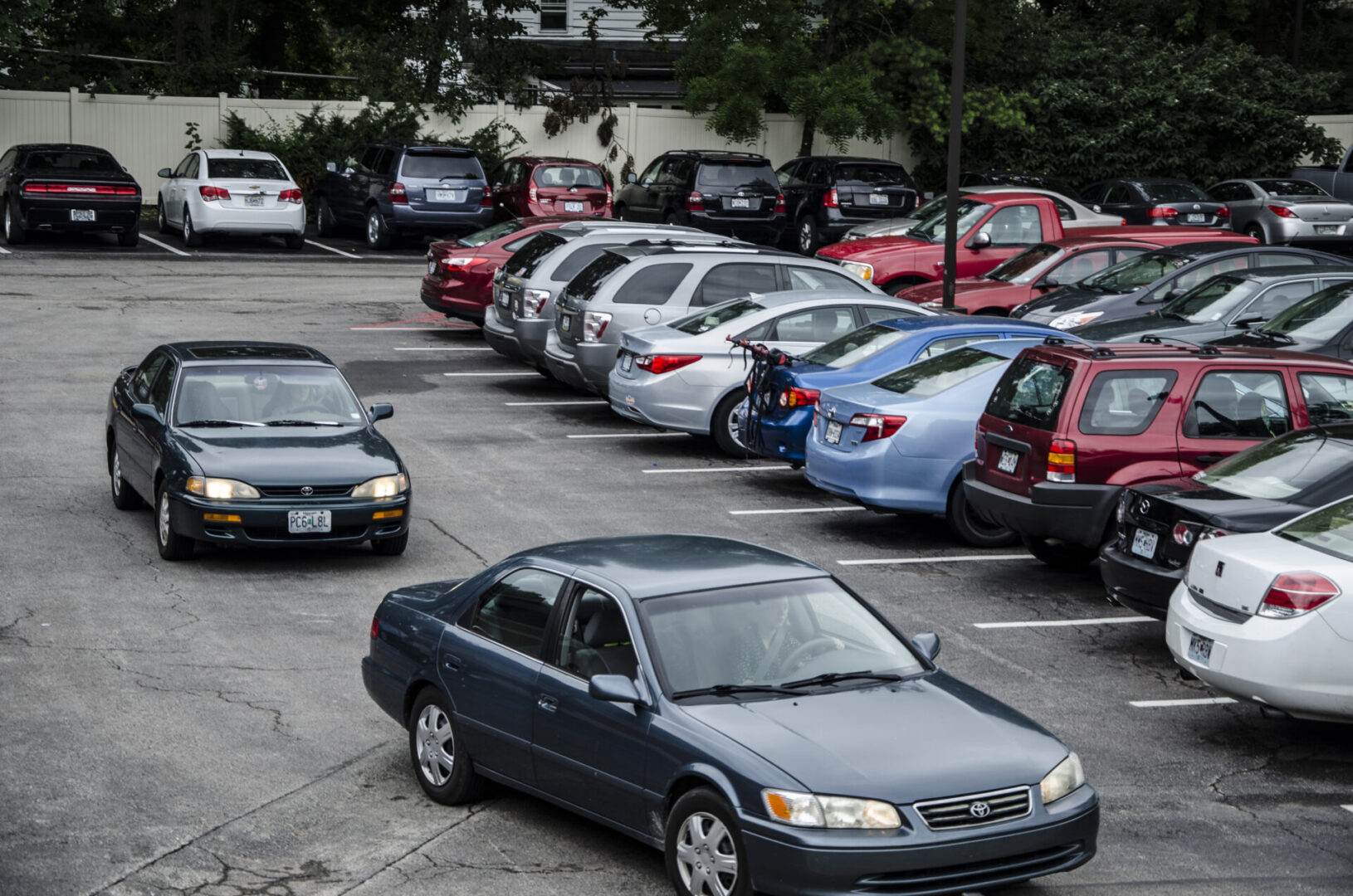 Multiple cars in outdoor parking area.