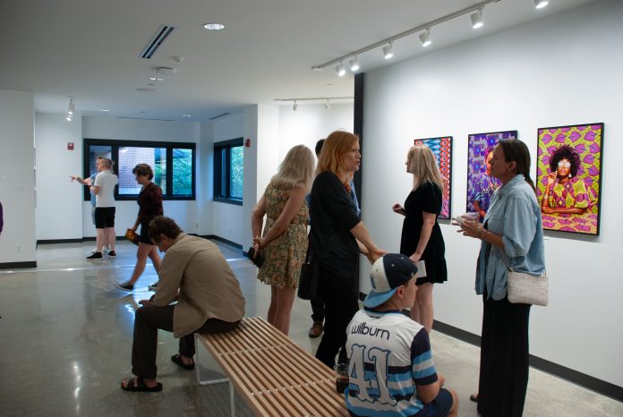 Visitors exploring vibrant artwork in exhibition