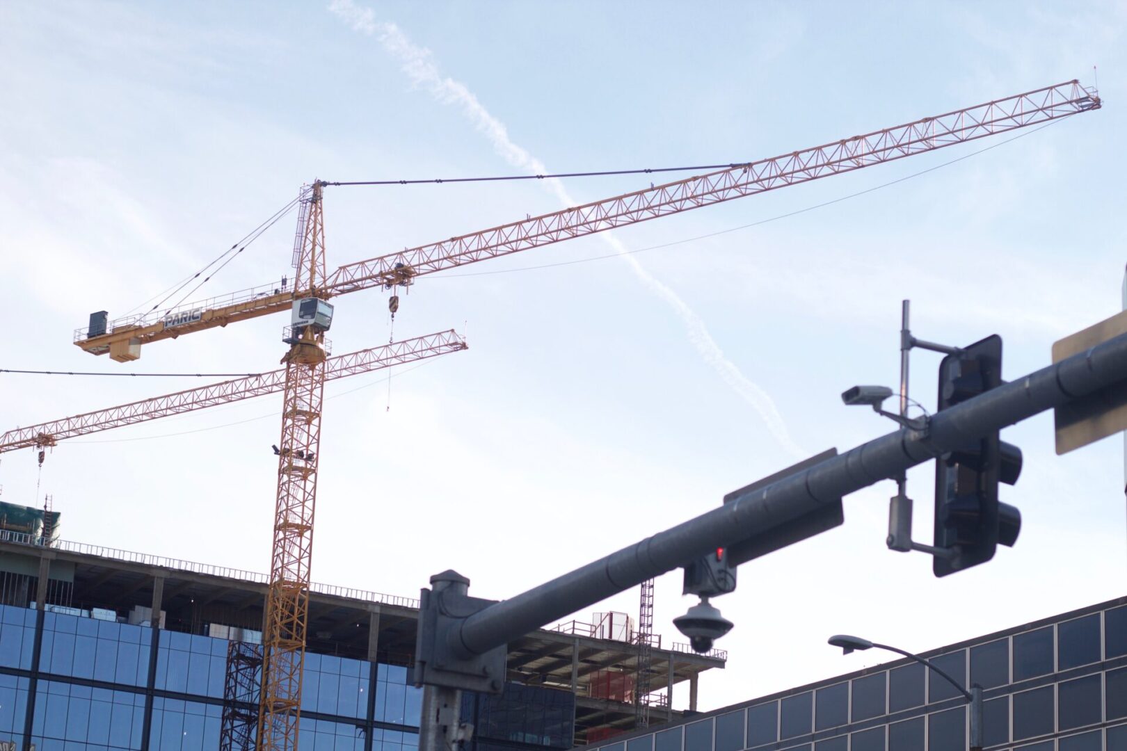 Cranes silhouetted against a blue sky