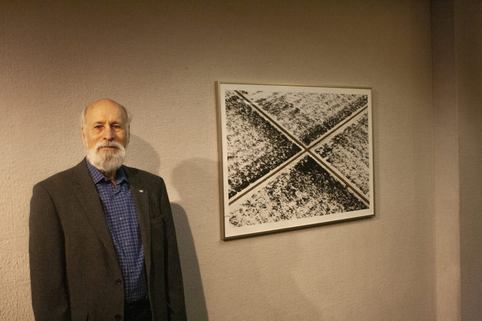 Man standing beside abstract artwork