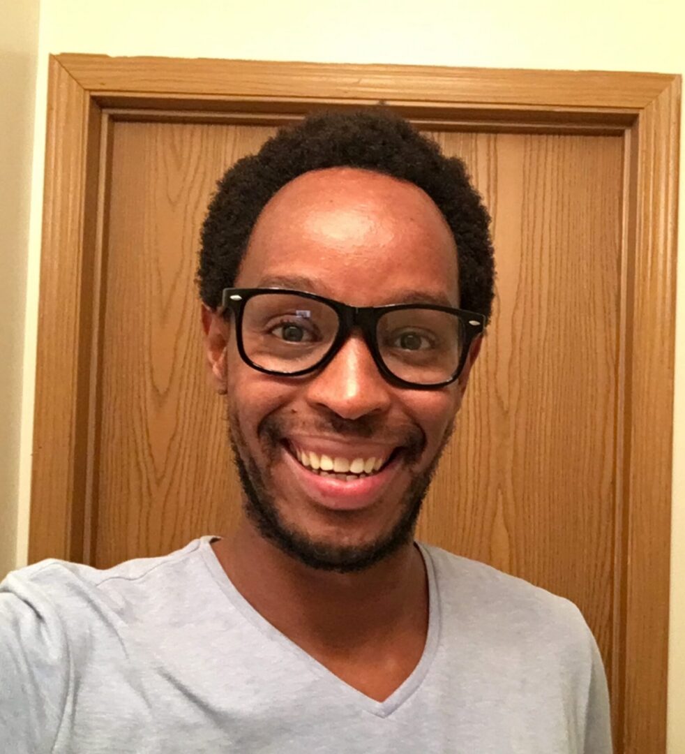 Happy person wearing glasses indoors