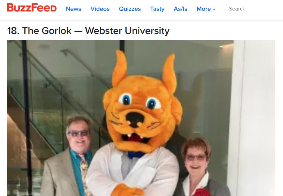 Mascot in white coat with two adults