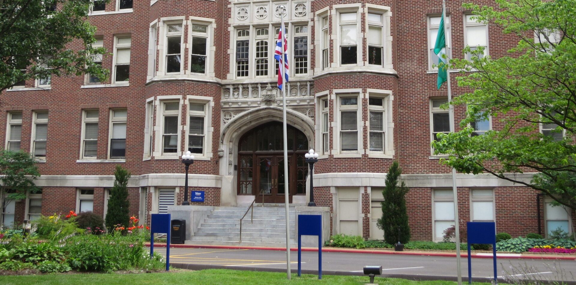 Red brick building with flags displayed