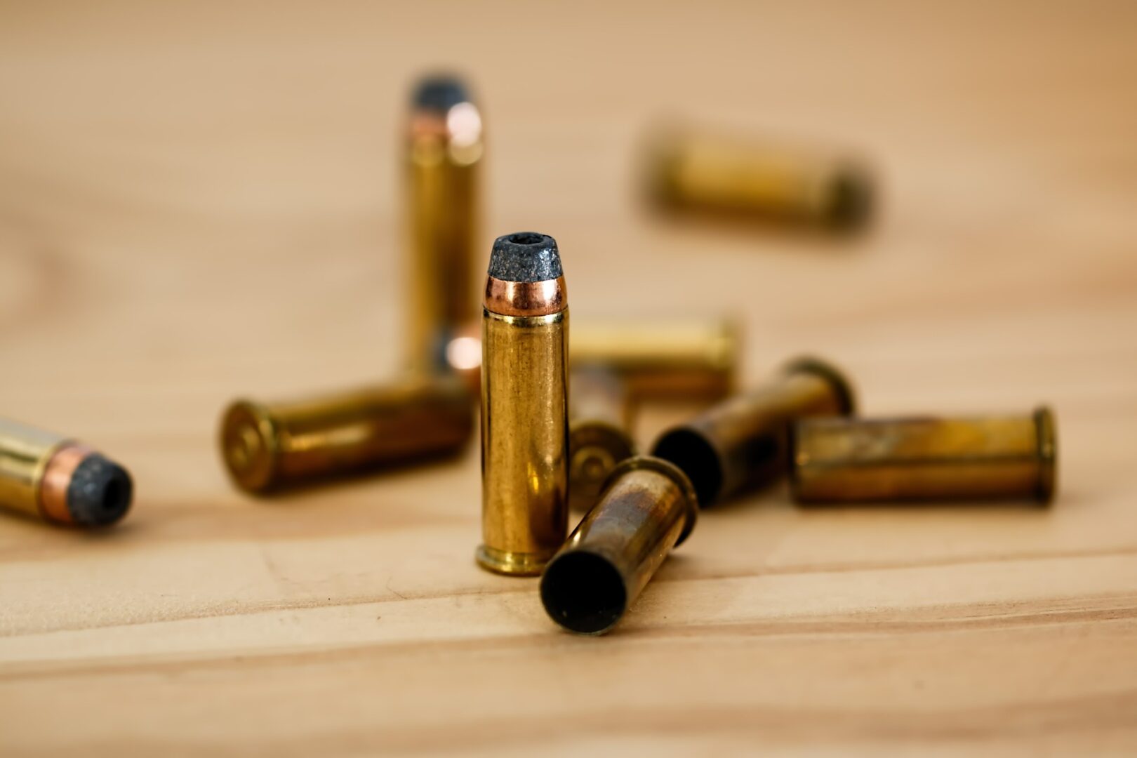 Brass bullets on wooden background