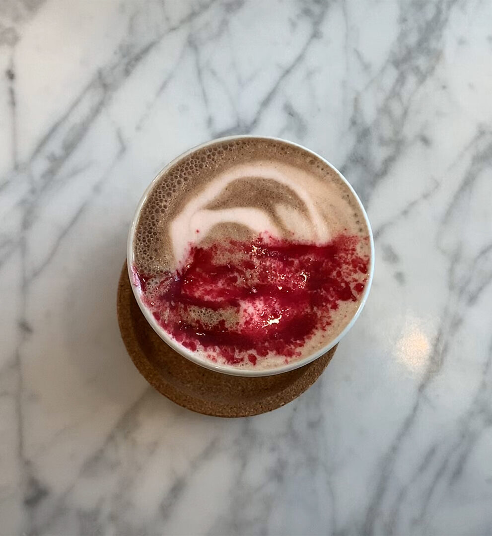 Creamy latte with vibrant red design