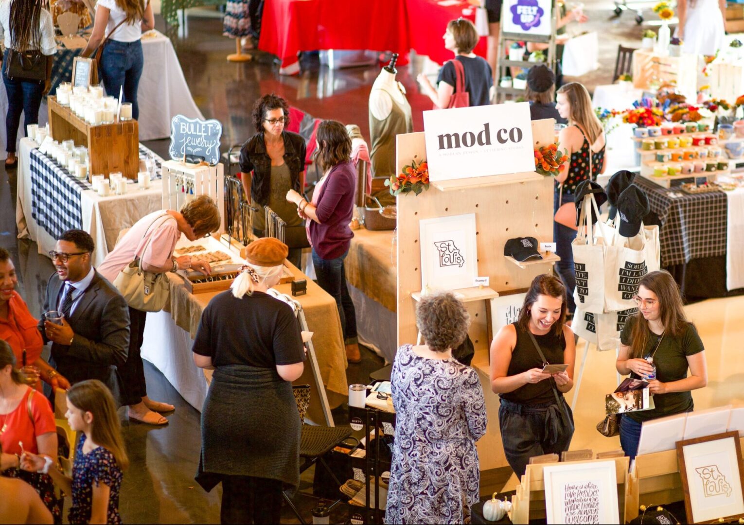 People browsing stalls at indoor market