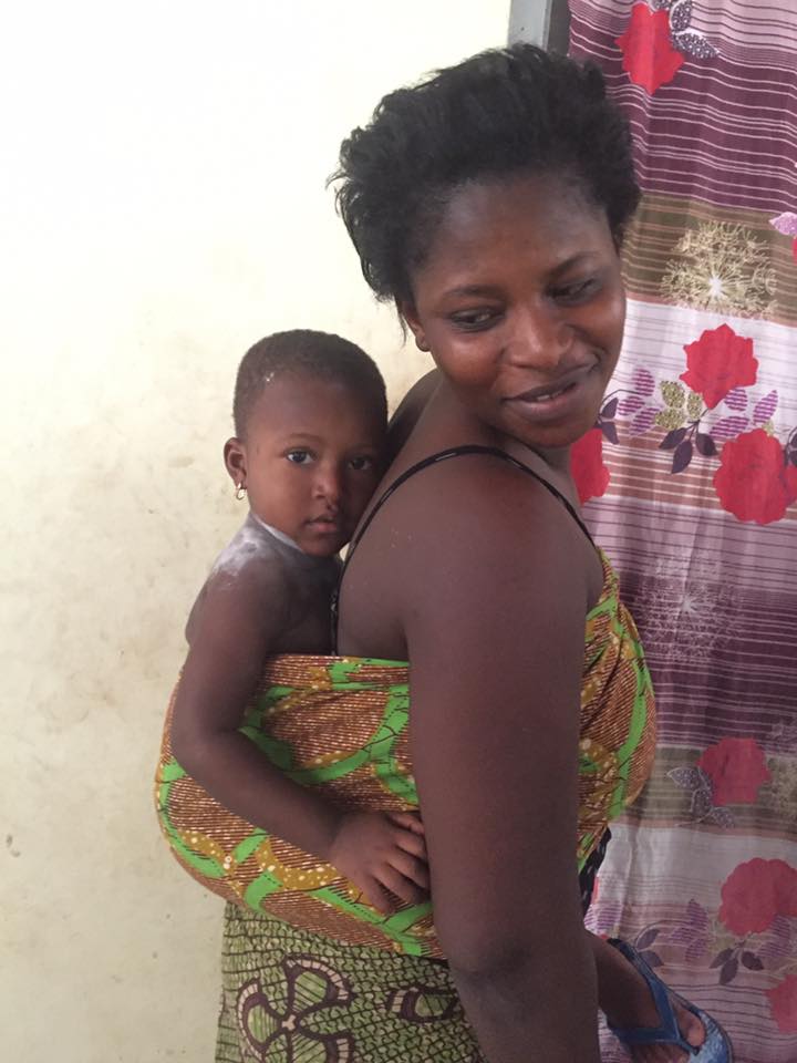Parent with infant in colorful fabric wrap