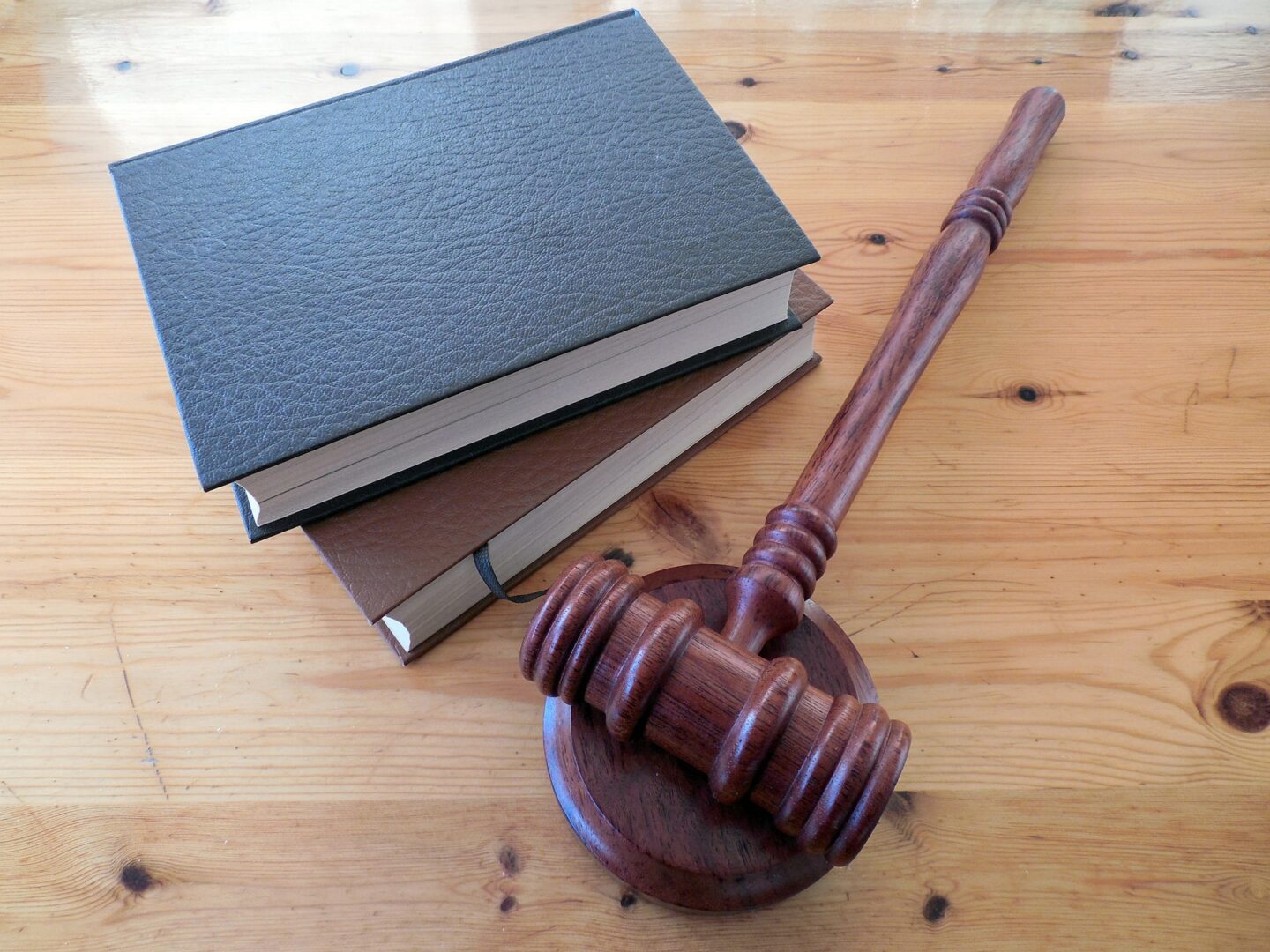 Gavel and books on wooden table