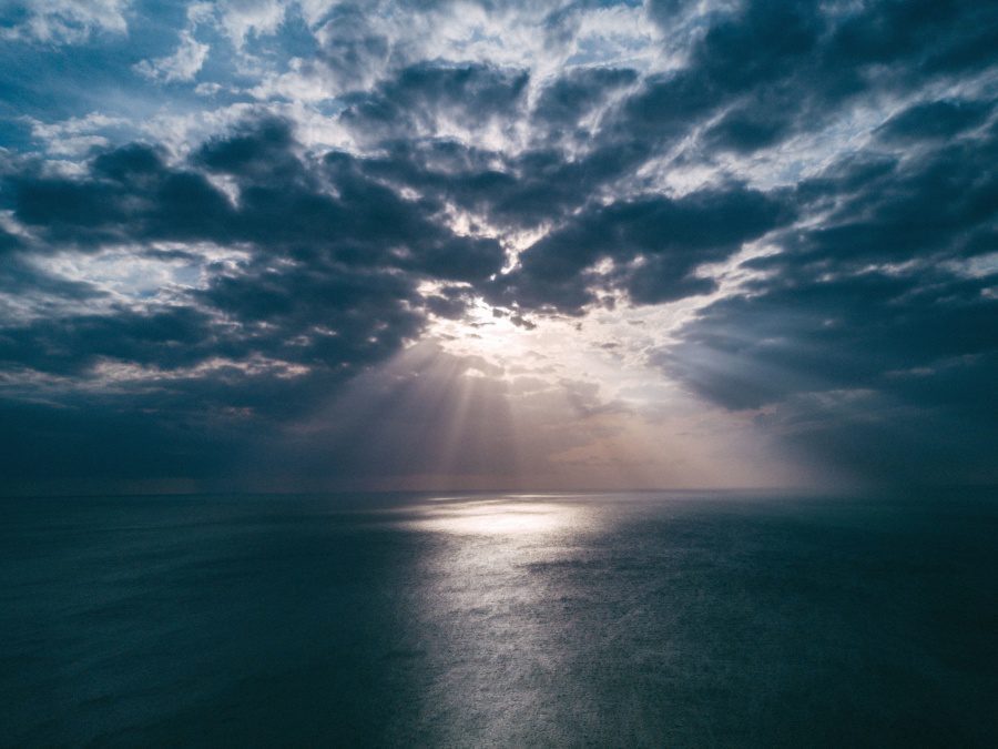 Ocean view with sunrays through clouds