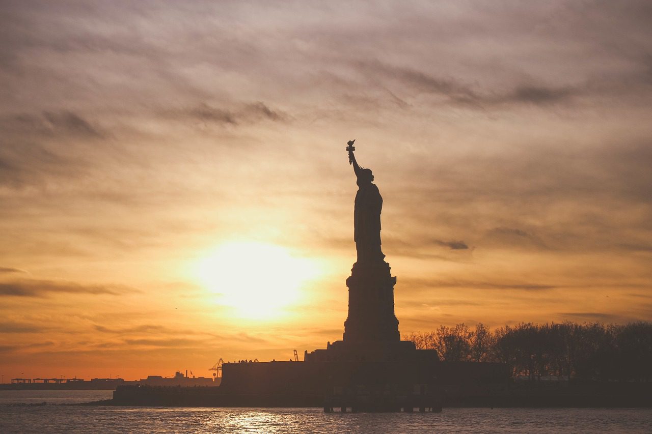 Silhouette of Liberty with sunset backdrop