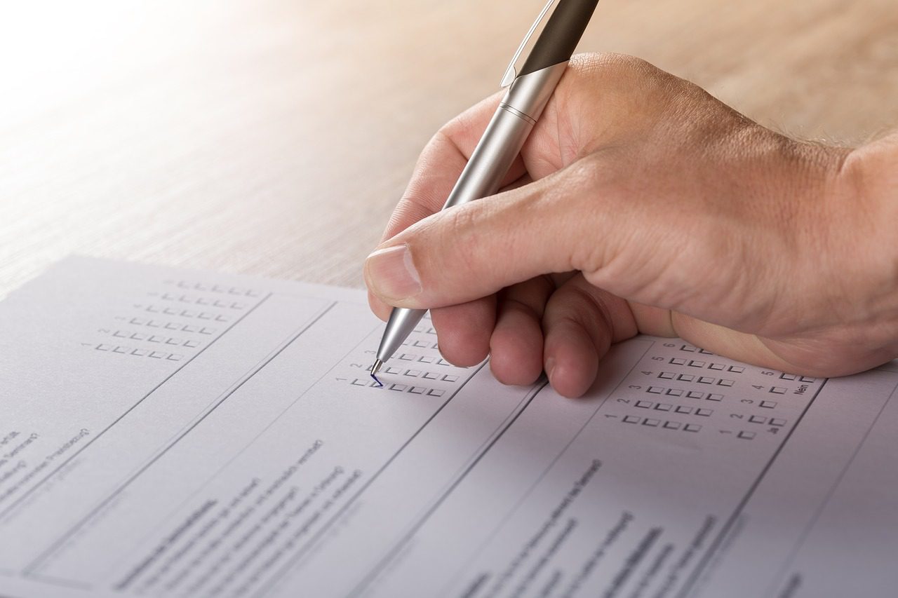 Hand completing a questionnaire
