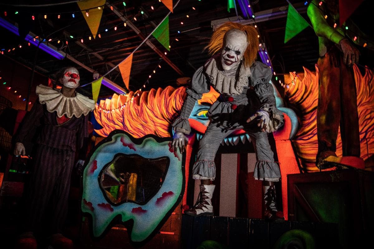 Spooky carnival scene with sinister clown