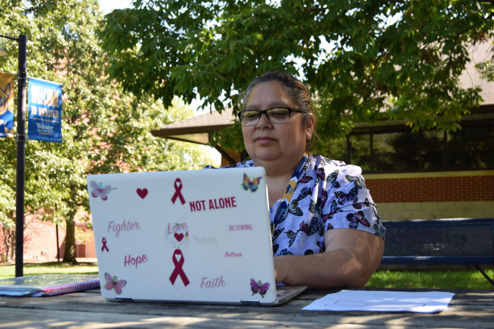 Norma Zamora works on her homework while sitting in The Quad. Photo by Styx Nappier
