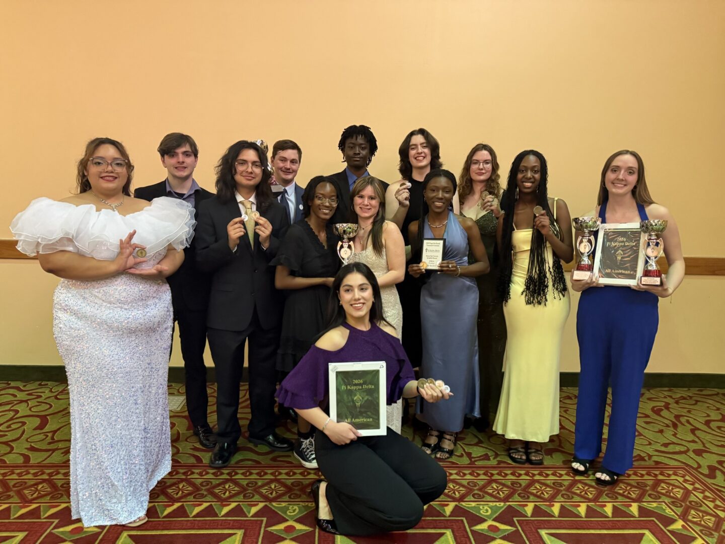 The Speech and Debate Club showcase their awards at the Phi Kappa Delta National Tournament banquet. Photo contributed by Gina Jensen