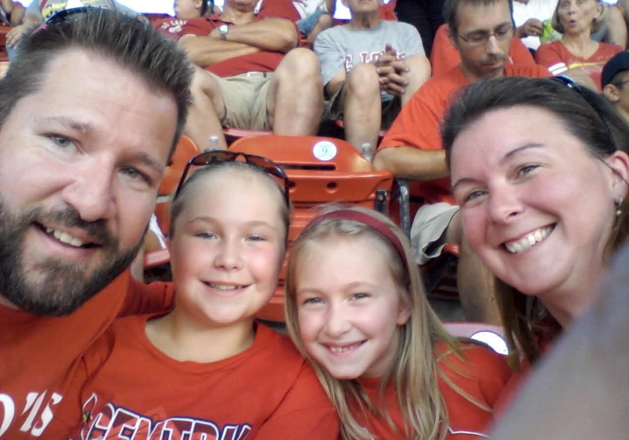 Family in red shirts at game