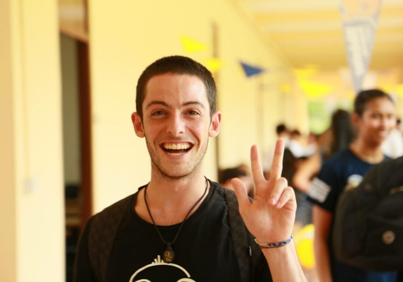 Happy individual in a hallway