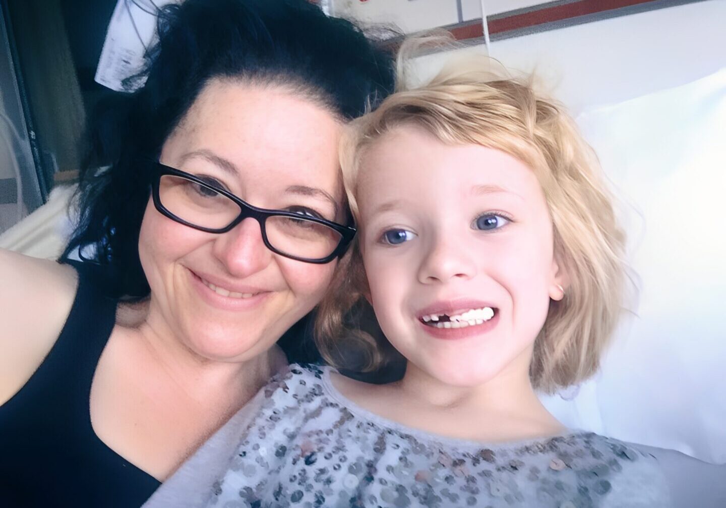 Woman and child smiling together in hospital