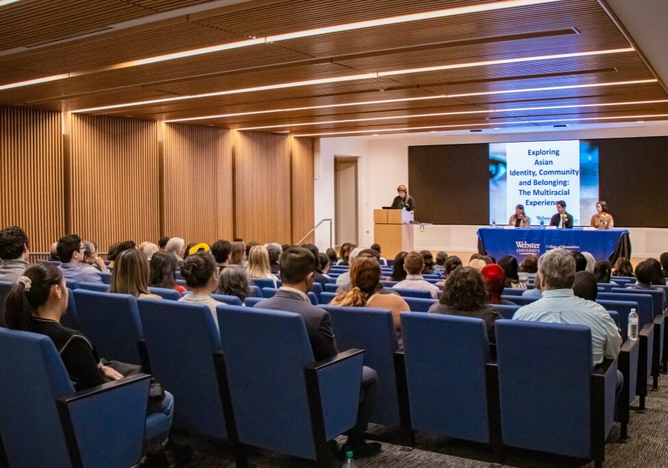 Speaker presenting at a blue-themed event