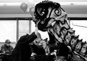 Festive lion dance indoors with audience