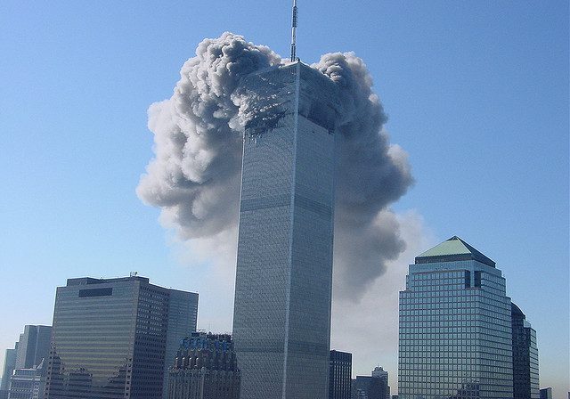 High-rise structure surrounded by thick smoke
