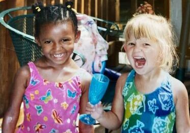 Kids smiling with colorful outfits