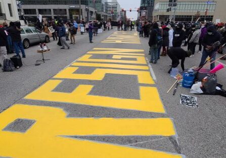Protesters paint message on road