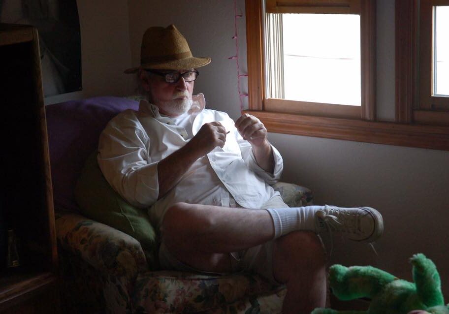 Man in white shirt seated casually