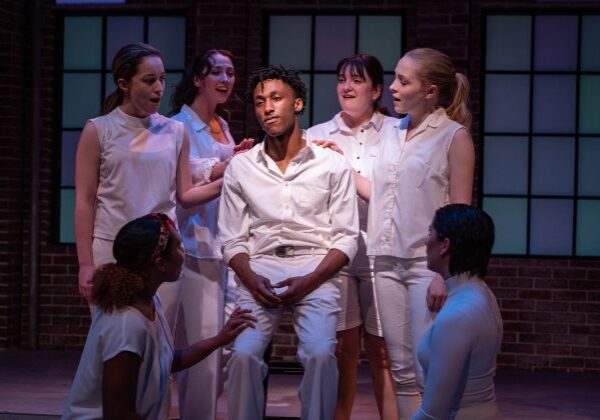 Diverse cast in dramatic stage scene