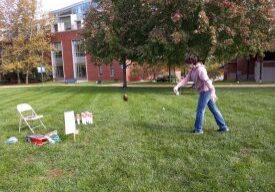 Throwing ball at wooden pins