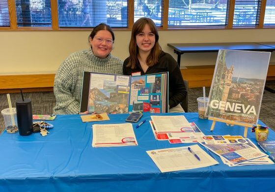 Two people showcasing Geneva travel information