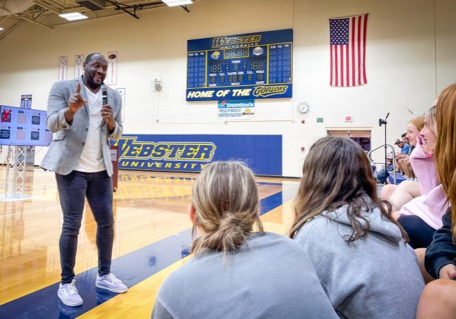 Speaker engaging audience in gymnasium