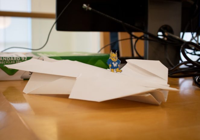 Small mascot on paper airplane