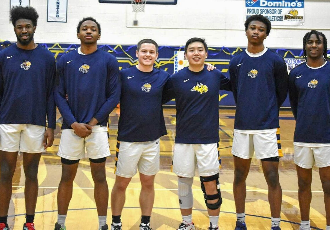 Smiling athletes standing together in gym