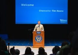 Speaker at podium during presentation
