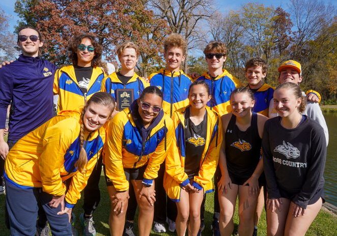Happy athletes gathered by a lake