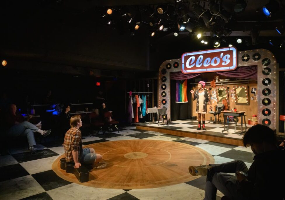 Intimate theater scene with spotlight stage